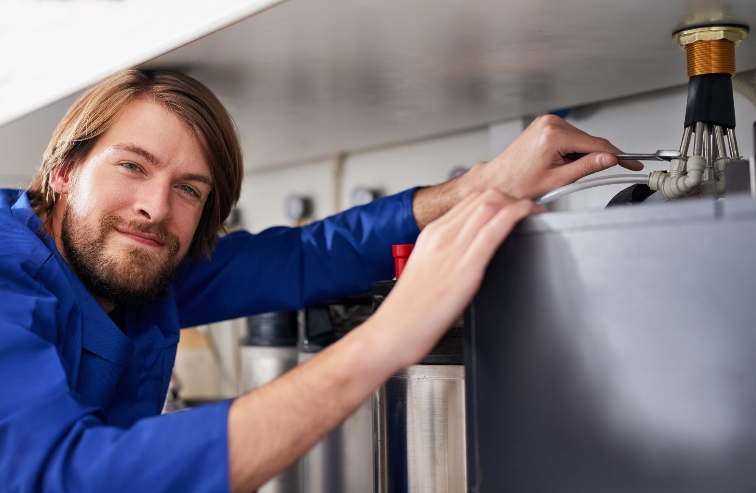 Technician servicing a residential water heater tank in South Pasadena